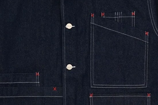 Button placket and twin-needle stitching on indigo denim