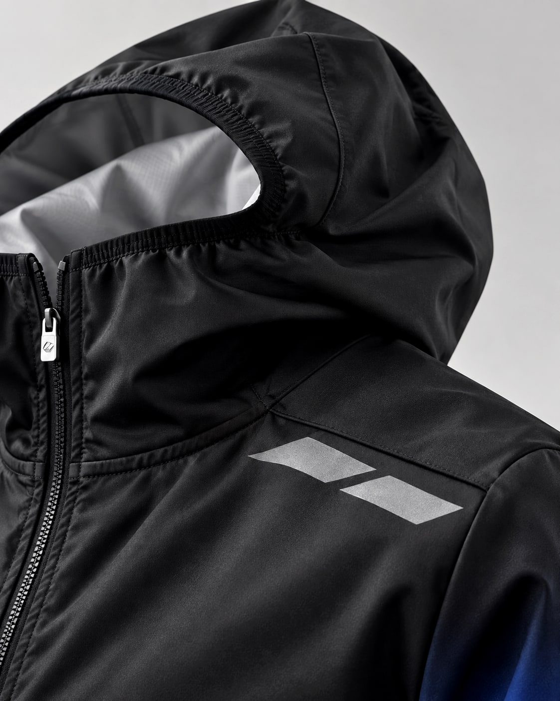 Close-up of the technical jacket hood and reflective construction