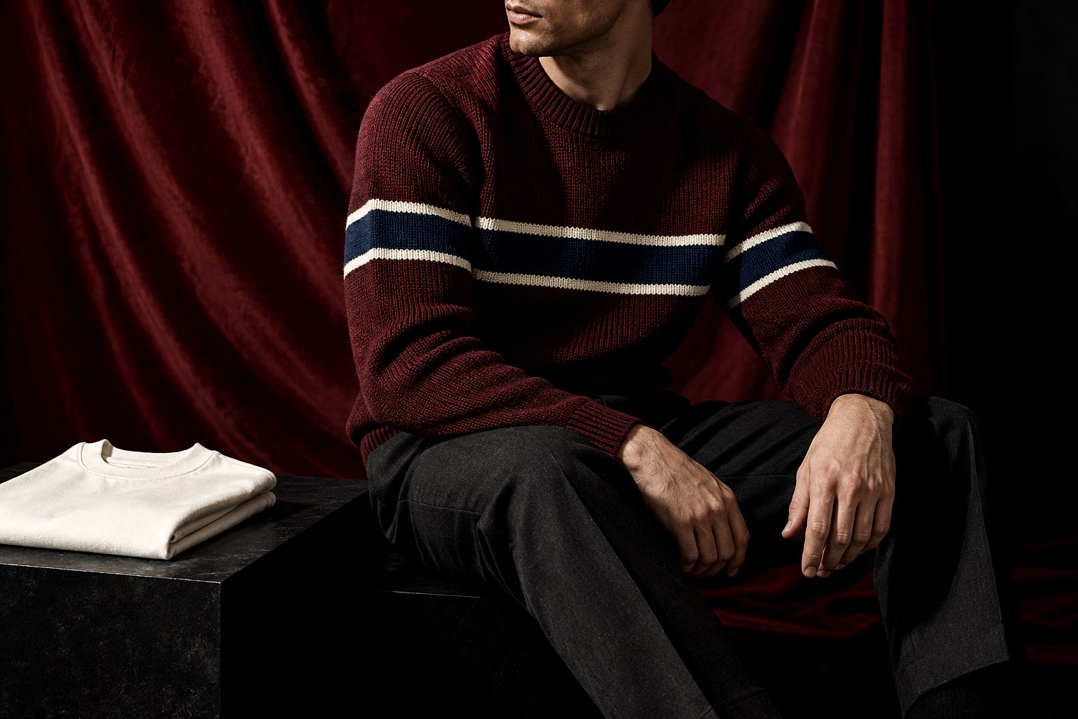 Oxblood knit with navy and ivory stripes styled against a deep burgundy studio backdrop