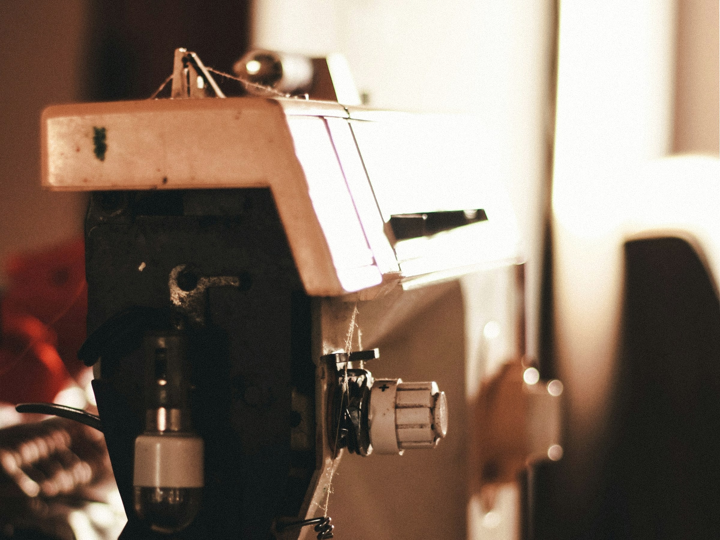 Close-up of a sewing machine in warm workshop light