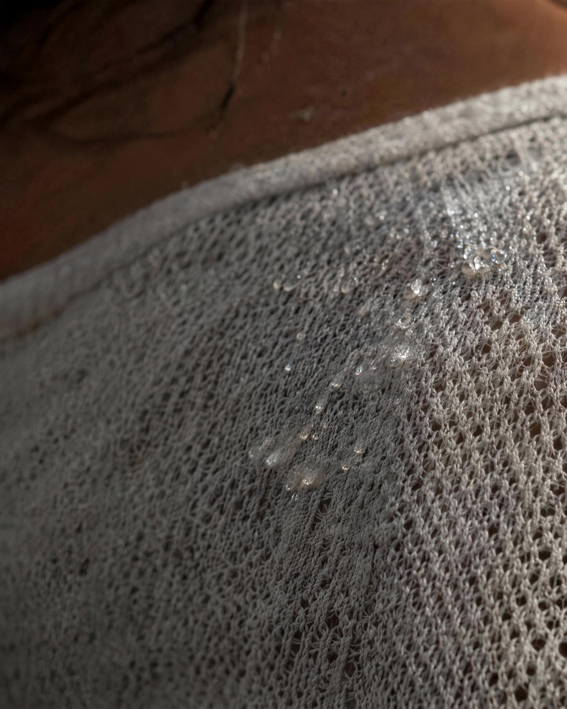 Close-up of moisture on a light running singlet