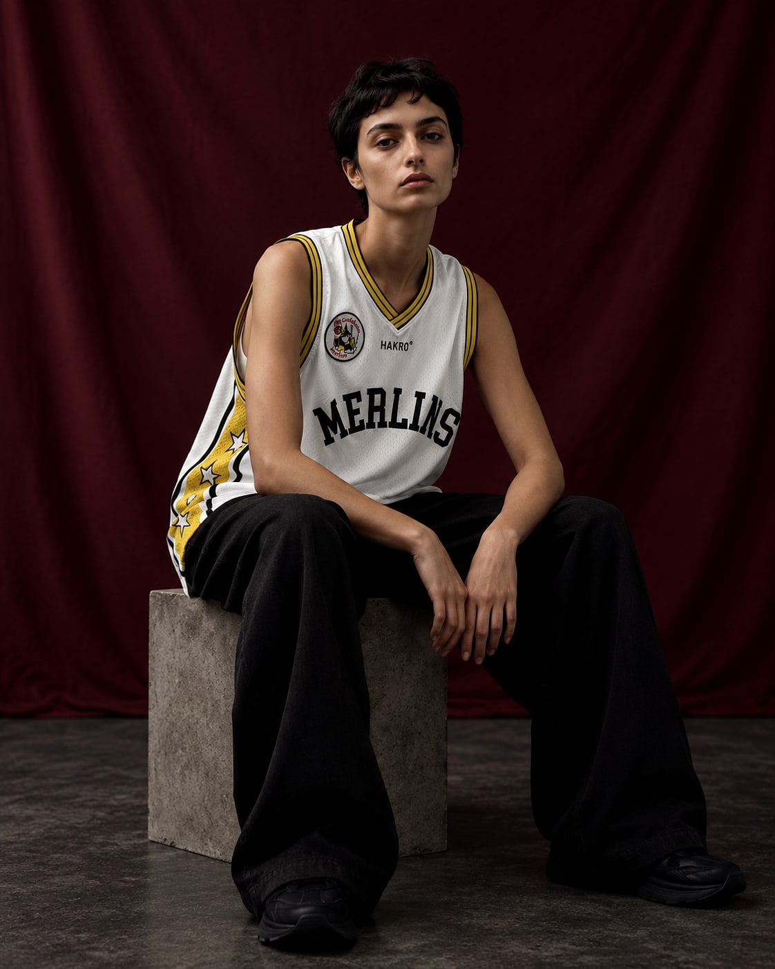 Model wearing a basketball singlet from a delivered club lifestyle capsule